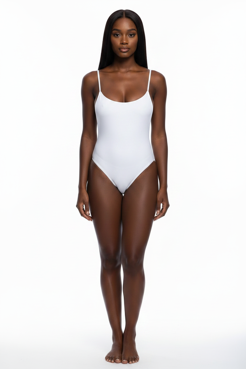 A woman modeling a white one-piece bodysuit with thin spaghetti straps and a scoop neckline, standing against a seamless white studio background.