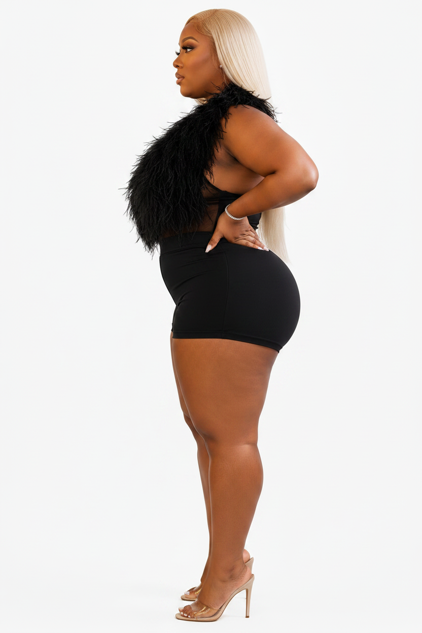 Woman wearing a black outfit with feathered details on a white background