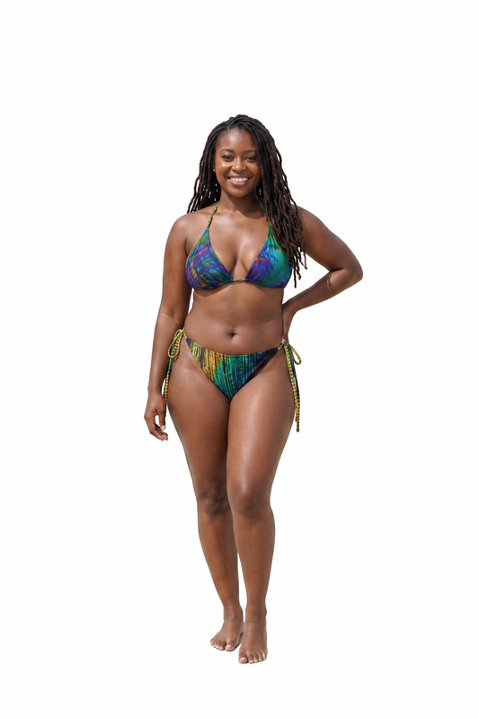 A woman modeling a two-piece string bikini with a vibrant multicolor tie-dye pattern of blue, green, yellow, and purple, set against a solid white background.