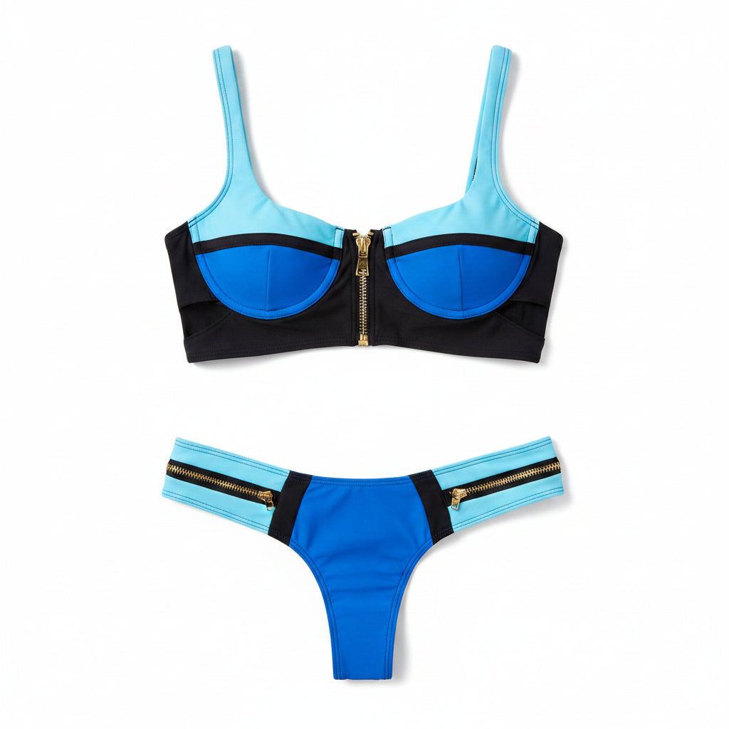 Blue and black bikini set with gold zippers on a white background