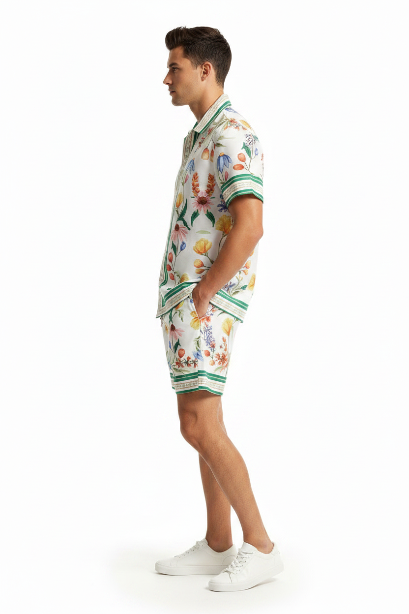 Man wearing a floral shirt and shorts on a white background