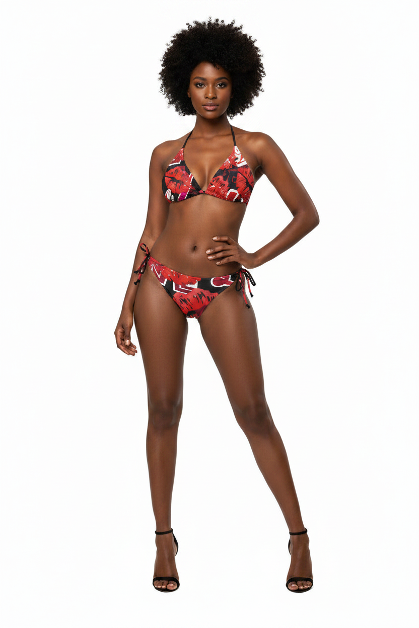 A woman modeling a red, black, and white patterned string bikini against a plain white background.