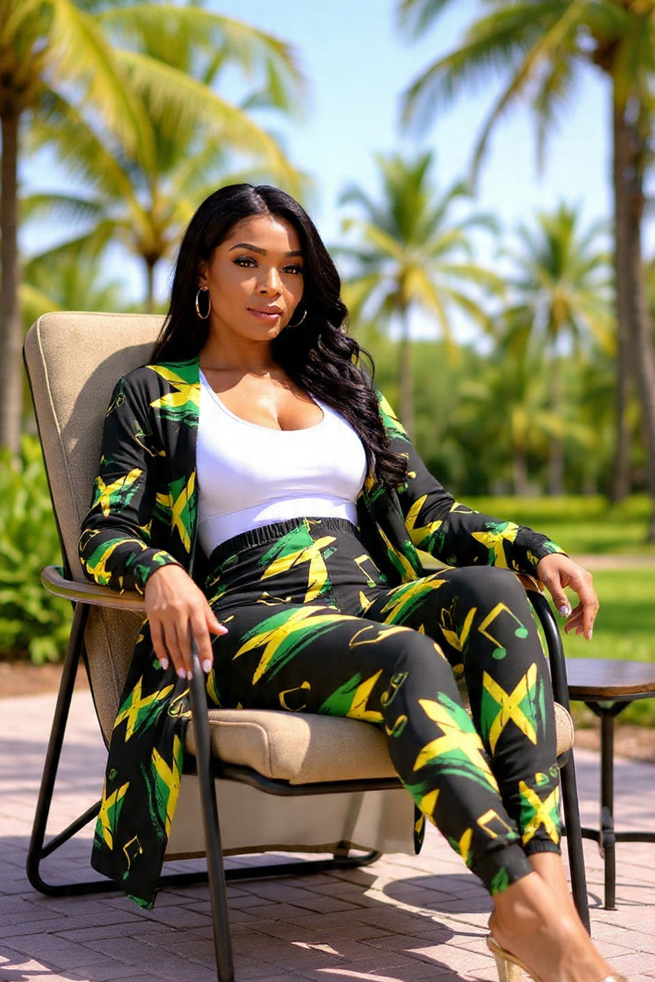 Woman in a colorful outfit sitting on a chair with palm trees in the background
