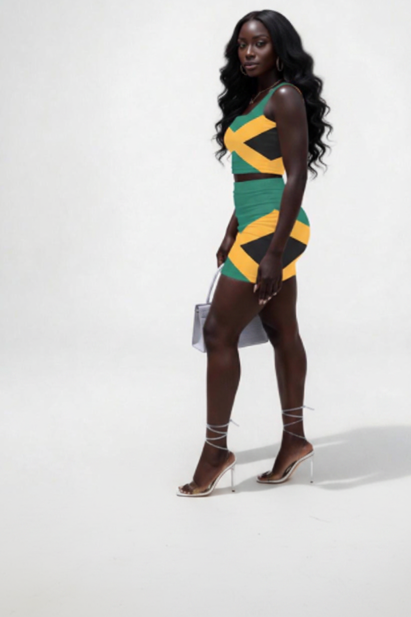 A woman modeling a sleeveless bodycon mini dress with a bold geometric pattern in green, yellow, and black, styled with black lace-up high heels and holding a small gray handbag against a plain light gray studio background.