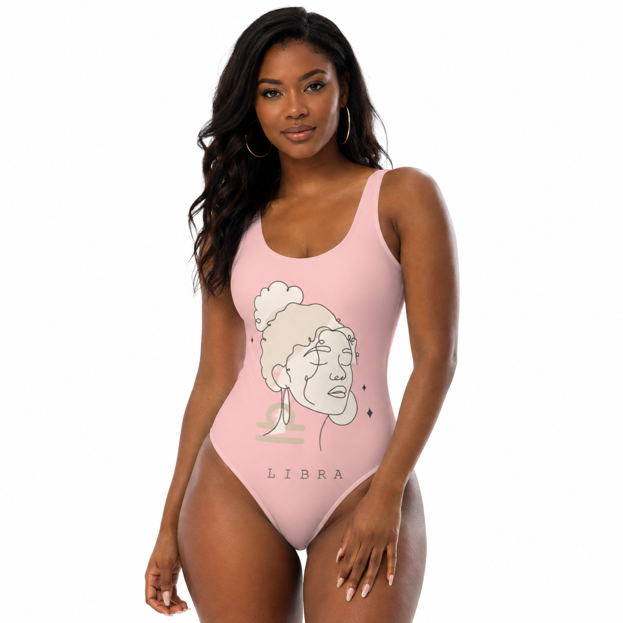 A woman modeling a light pink one-piece swimsuit with a minimalist Libra zodiac sign graphic on the front, set against a plain white background.