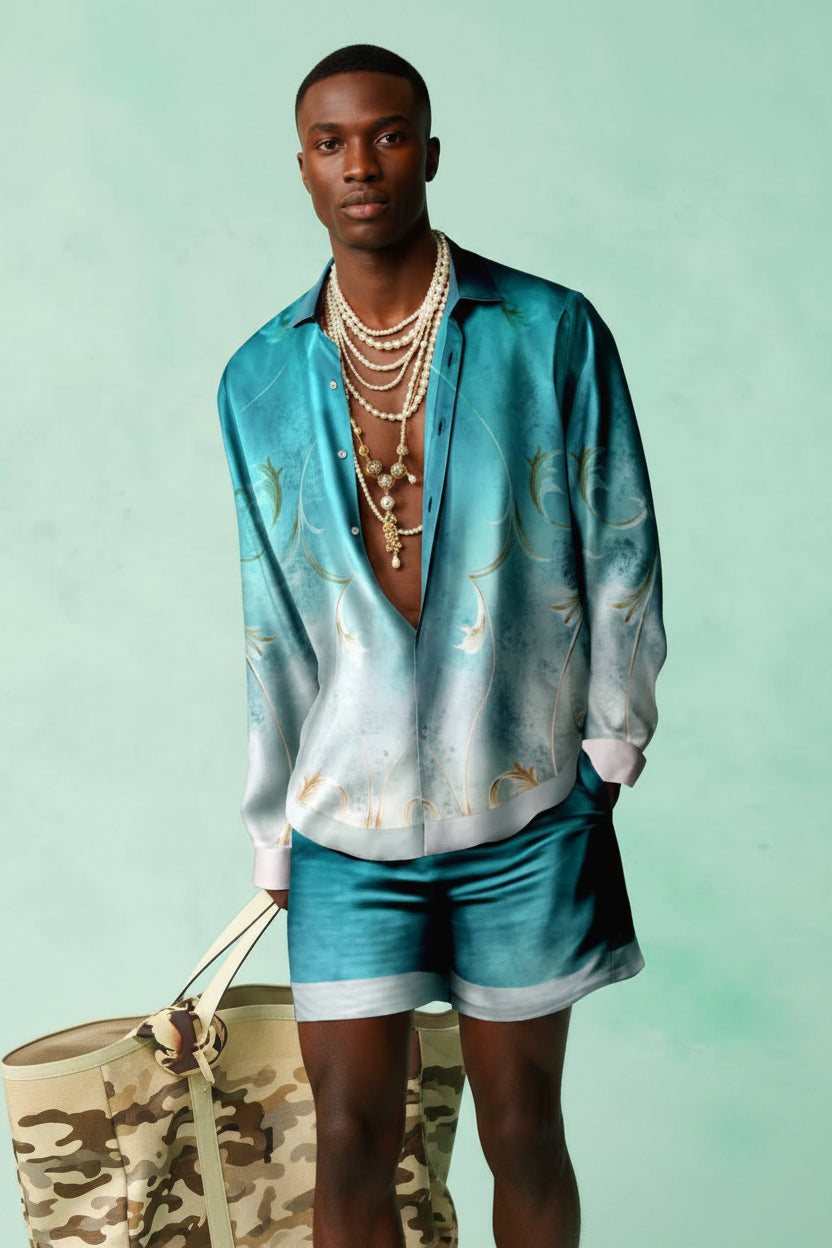 Person wearing a turquoise patterned shirt and shorts against a light green background