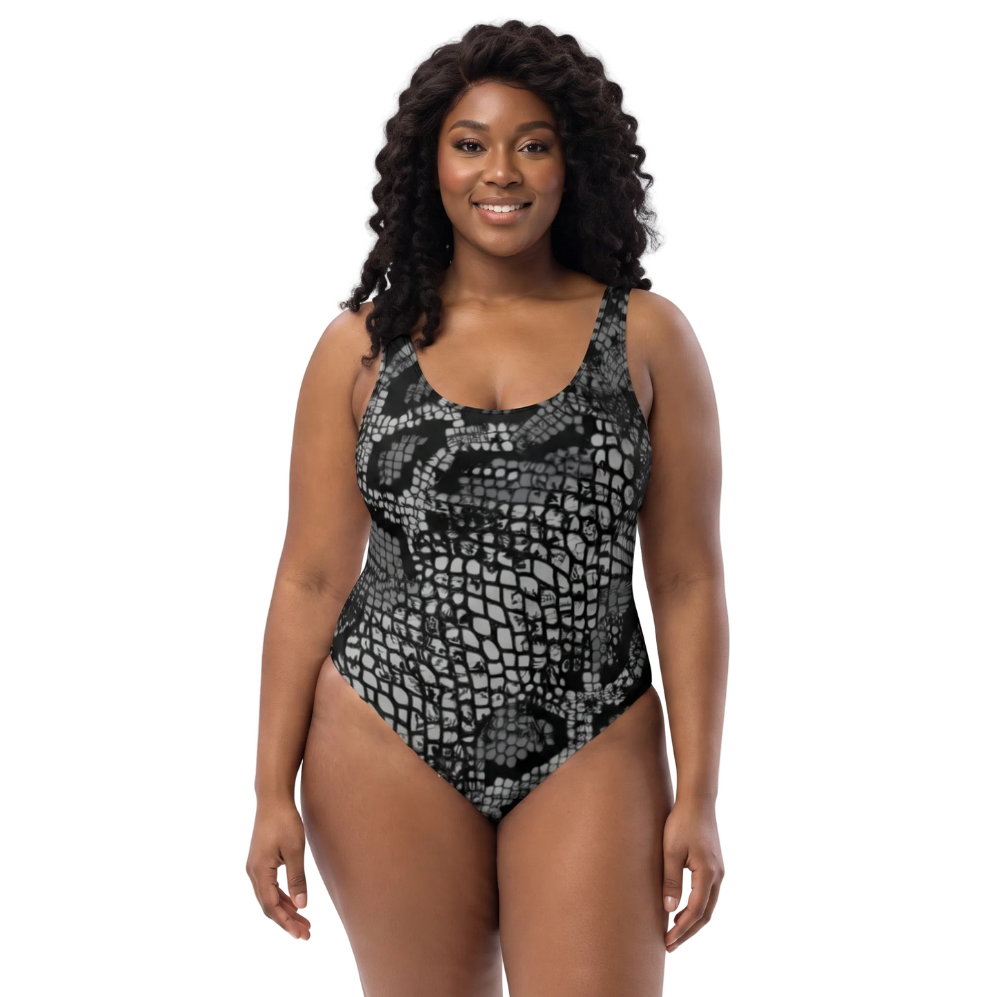 A woman modeling a one-piece swimsuit with a black and gray snakeskin pattern against a plain white background.