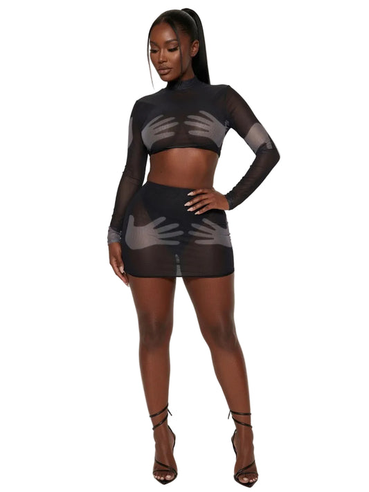 Model wearing a black sheer outfit on a white background