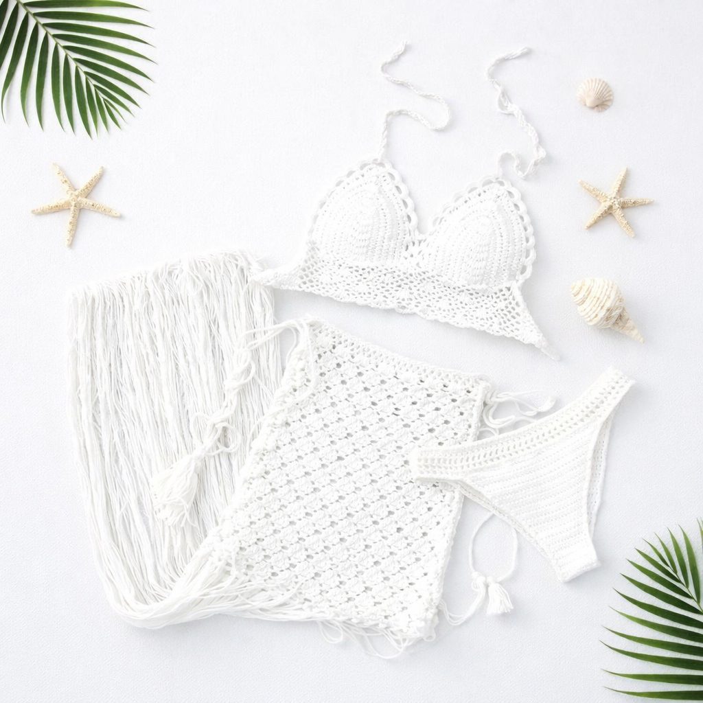 White crochet bikini set on a light background with starfish and palm leaves.